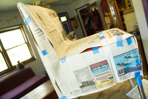 Use plenty of newspaper and plenty of tape to make your chair cover pattern.