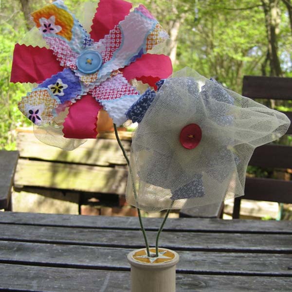 Make a sweet, fabric bouquet from your stash of fabric scraps. They're a cute decoration for your house or as a gift.